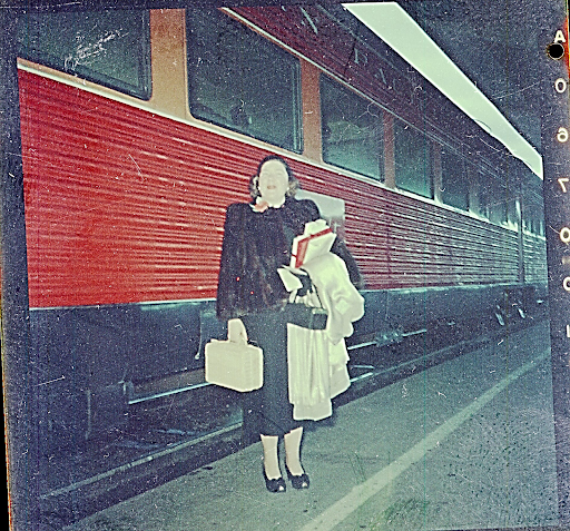 Woman standing next to a train